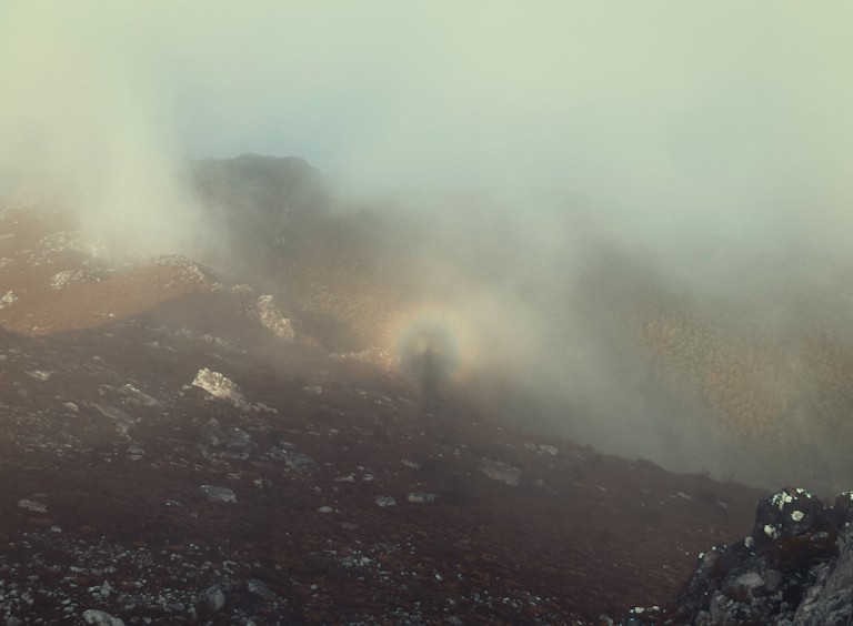 A biblical moment featuring a circular rainbow with the silhouette of a man.